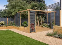 a wooden gazebo in the middle of a garden