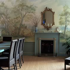 a dining room with a fireplace and wall painting on the walls, chairs are in front of it