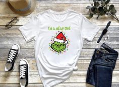 I'm a Mean One T-Shirt, Grinches T-Shirt, Xmas Tee, Grinch Tee, Merry  Xmas Tee, Cute Christmas Tee, Grinch Gift Shirt, Funny Grinchmas Tee Merriscustomtees Return policy: Since it is a print on demand type business, we are unable to accept a return, unless there is a defo on the product. If there is problem with the product, please contact us. Available T-Shirts Stills: Unisex - V neck Lady - Tank Top Lady - Long Sleeve - Youth Material: We use white vinyl for all colors but black vinyl for whi Grinch Smile, Xmas Tees, Christmas Funny, Cute Shirt, Christmas Tees, Christmas Day, Cute Christmas, Grey Shirt, Merry Xmas