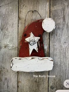 a red and white wooden sign with a star on it