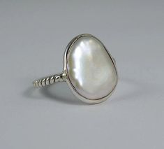 "Fresh Water Pearl Ring, 925 Sterling Silver, Free Form Gemstone, Twisted Band Ring, Cabochon Stone, Statement Ring, Christmas Gift, Boho Metal :- 925 Sterling Silver (Stamp on the Product) \"\"\"\"Gemstone Size depends on the Ring Size.\"\"\"\" \"\"\"\"The Product you will receive may vary from the image as no two gemstone are similar and images cannot define exact product definitions. \"\"\"\" Shipping Policy:- I mainly use USPS, DHLE, PPS, UPS, FedEx for the shipping of goods depending on the Geometric Silver Jewellery, Unique Ring Designs, Pearl Mala, Twisted Band Ring, Silver Jewelry Diy, Wear Pearls, Freshwater Pearl Ring, Fine Silver Jewelry