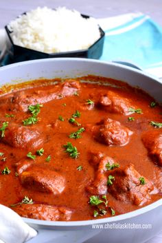 a white bowl filled with meat and sauce