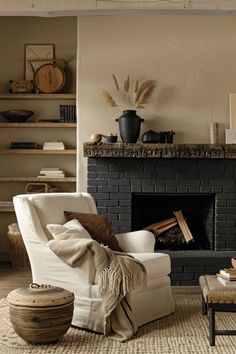 a living room filled with furniture and a fire place covered in blankets on top of a rug