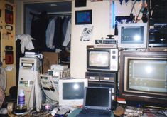 a messy room with old computers, televisions and other electronic equipment on the floor