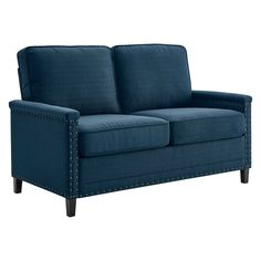 a blue couch with studding on the armrests and back rests against a white background