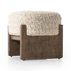 the foot stool is made out of wood and sheepskin