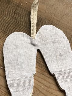 an unfinished piece of cloth hanging from a string