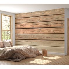 a bedroom with wooden walls and flooring