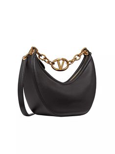 Valentino Garavani Moon small hobo bag in leather with chain and metal VLogo signature detail. Equipped with a chain and detachable leather shoulder strap, the bag can be worn as a crossbody/shoulder bag or carried by hand. Gold tone-finish chain and hardware Removable leather strap Zipper closure Nappa leather lining. Interior: one slip pocket Made in Italy SIZE Shoulder strap drop length: 55 cm / 21.7 in. Chain drop length: 22cm / 8.6 in. Dimensions: W 29 x H 23 x D 11 cm / W 11.4 x H 9 x D 4. Evening Crossbody Bag With Metal Logo, Evening Shoulder Bag With Metal Logo, Luxury Shoulder Bag With Metal Logo, Luxury Shoulder Bag With Chain In Crossbody Style, Luxury Chain Shoulder Bag Crossbody, Luxury Chain Crossbody Shoulder Bag, Luxury Chain Shoulder Crossbody Bag, Designer Shoulder Bag With Chain Detail, Designer Shoulder Bag With Chain