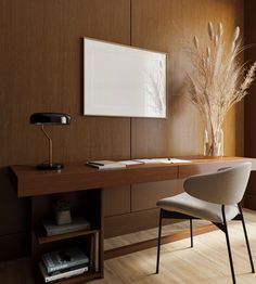 a desk with a chair and a lamp on it in a room that has wood paneling