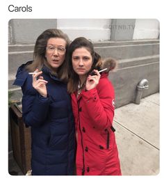 two women standing next to each other on the street