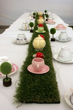 a long table with plates and cups on it