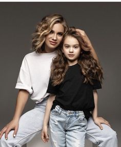 two women sitting next to each other posing for the camera