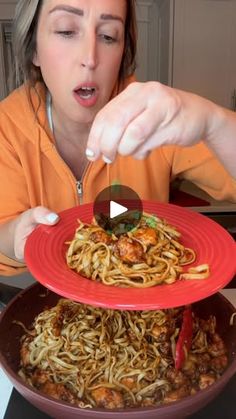 a woman is eating spaghetti with chopsticks