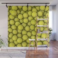 a tennis ball wallpaper mural in a living room with a ladder to the side