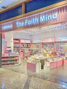 the interior of a store that has pink and white items on display in front of it