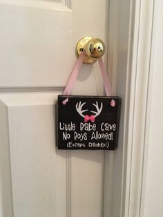 a door hanger with a sign that says little pee cave no poop allowed