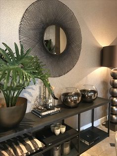 a living room filled with furniture and a large mirror on top of it's wall