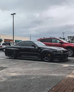 two cars parked next to each other in a parking lot