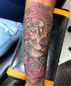 a woman with a tiger and roses tattoo on her arm