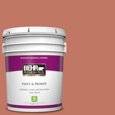 the behr paint and primer in one is shown on a dark purple background