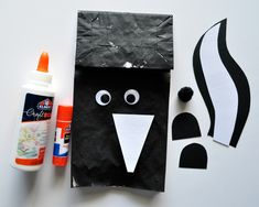 the paper bag is made to look like a black and white bird with its mouth open