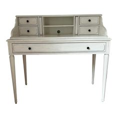 an antique white desk with drawers and legs