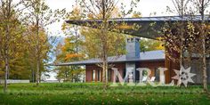 the house is surrounded by trees and grass