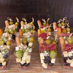 several small trays filled with different types of appetizers and snacks on sticks