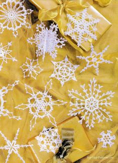 snowflakes on yellow fabric with bows and ribbons