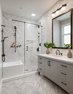 a white bathroom with herringbone tile on the walls and floor, along with a walk in shower