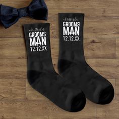 two grooms socks and a bow tie on a wooden floor with the words, gentlemen's grooms man 1222x