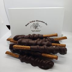 chocolate covered pretzels are stacked on top of each other in front of a card