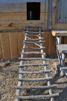 an old wooden ladder sitting next to a bench