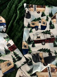 two pieces of fabric with campers and trees on them