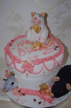 there is a cake decorated with mice on it