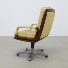 an office chair sitting on top of a white floor