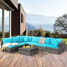 a blue couch sitting on top of a wooden deck