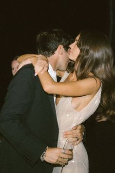 a man and woman embracing each other at a party