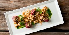 a white plate topped with food on top of a wooden table