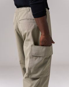 The Takibi Ripstop Pants are durable, fire-resistant cargo pants. The pants feature elastic shirring around the waist for comfort and flexibility, with spindle size adjusters at the waist and hems for a customizable fit. Additional features include a double cargo pocket on the right thigh, belt loops, and reinforced panels from the hem to the knee and on the seat. The material is an aramid-cotton blend with ripstop stitching throughout for fire resistance and durability. Elastic Shirring, Thigh Belt, Ripstop Pants, Cargo Pocket, Cargo Pants, The Knee, Stitching, Cotton Blend, Elastic