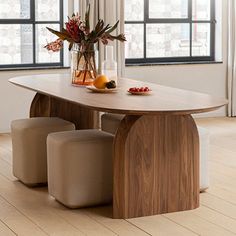 a wooden table with two chairs and a vase filled with flowers on top of it