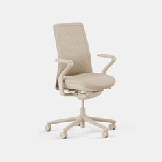 an office chair with wheels on the back and seat upholstered in beige fabric