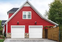 a red house with two white garage doors