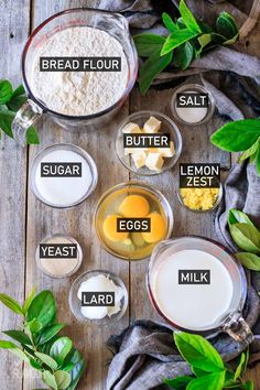 ingredients to make an egg recipe laid out on a wooden table with leaves and flour