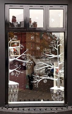 a person standing in front of a window with frosting on the windowsills