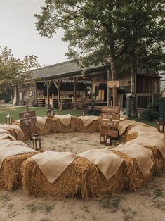 hay bales are arranged in the shape of a circle with chairs and signs on them