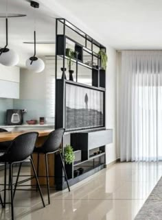 a living room filled with furniture and a flat screen tv on top of a wall