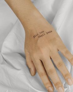 a woman's hand with the words, this too shall pass written on it