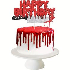 a red and white birthday cake with the word happy birthday on it's top